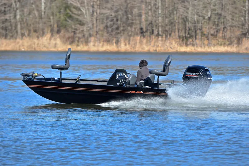 Slide: The Image of 2021 Lowe Legacy boat speeding on a lake with Mercury engine. - 25