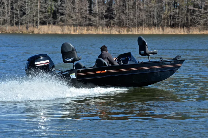 Slide: The Image of 2021 Lowe Legacy boat speeding on a lake with Mercury outboard motor. - 3
