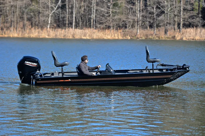 Slide: The Image of 2021 Lowe Legacy boat on a lake with Mercury outboard motor. - 5