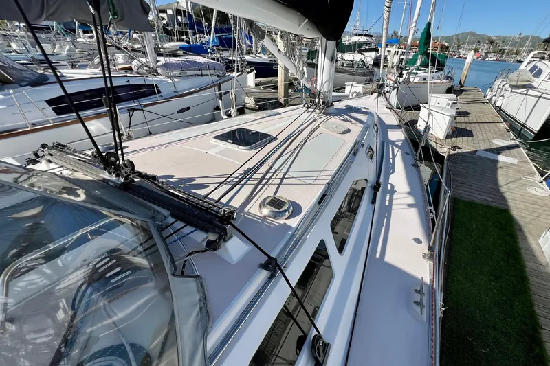 Slide: The Image of Catalina 400 sailboat from 1996 docked at a marina, showcasing deck and rigging. - 11