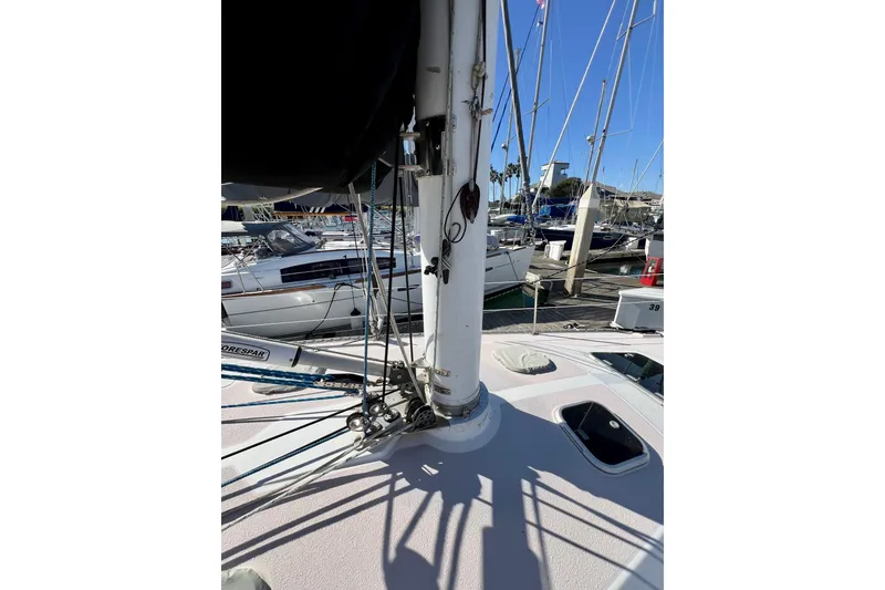 Slide: The Image of Sailboat deck view of a 1996 Catalina 400, featuring mast and rigging in a marina. - 15