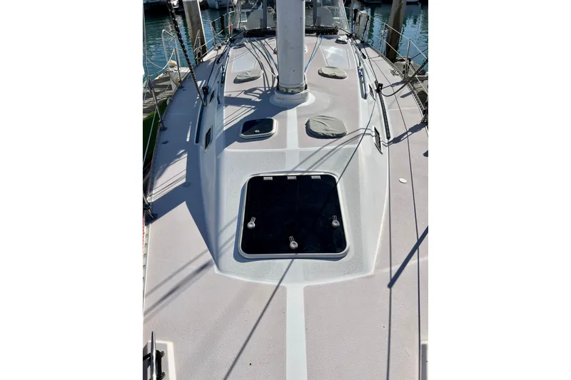 Slide: The Image of Deck view of a 1996 Catalina 400 sailboat, showcasing hatches and rigging. - 21