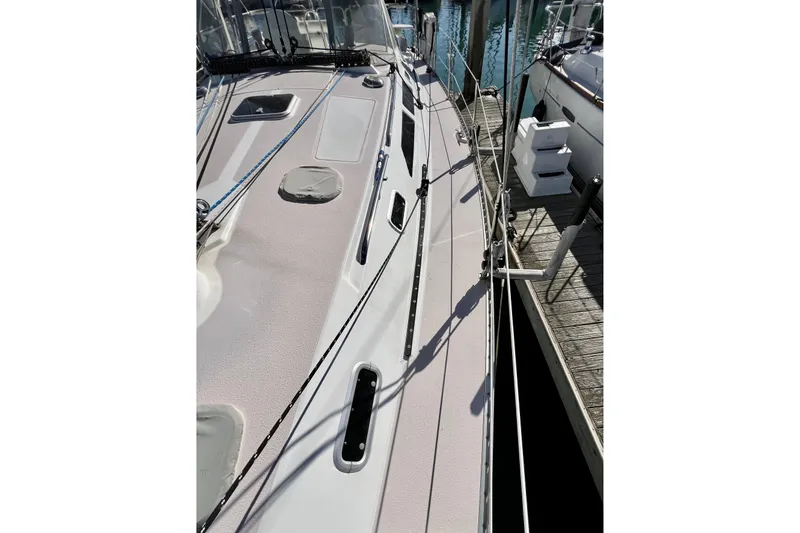 Slide: The Image of Deck view of a 1996 Catalina 400 sailboat docked at a marina. - 22