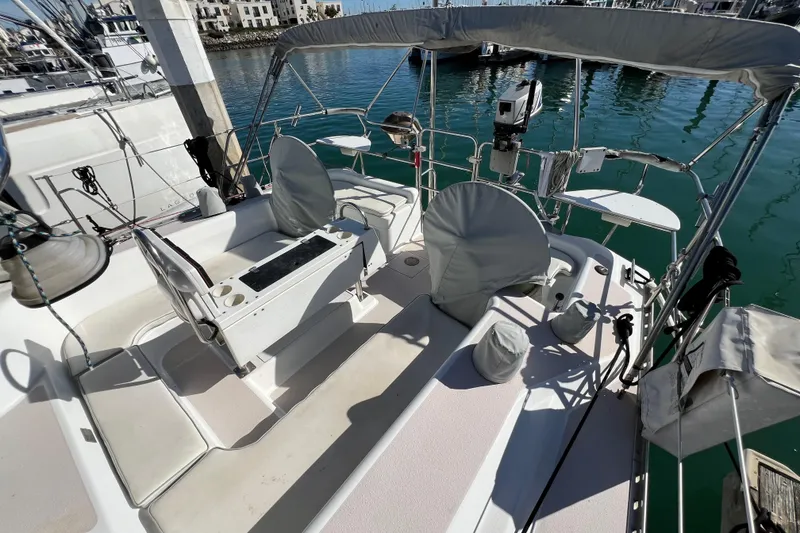 Slide: The Image of Sailboat cockpit of 1996 Catalina 400, docked in marina, featuring covered seating and equipment. - 26