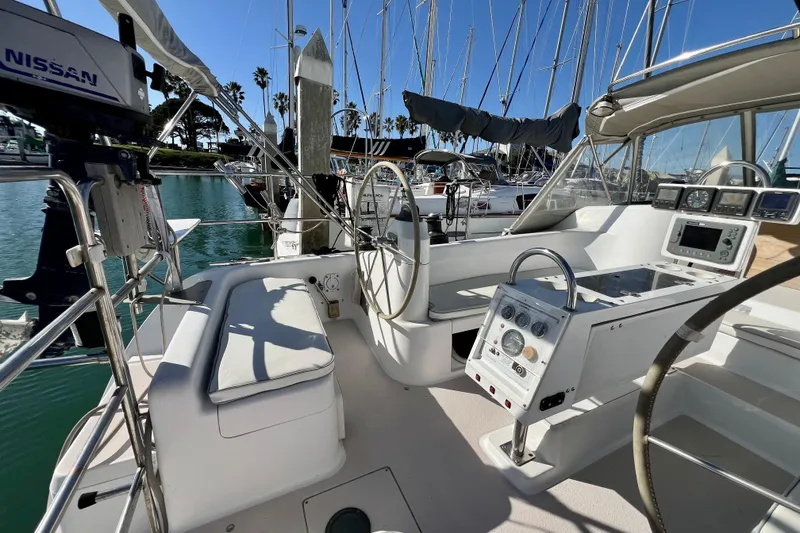 Slide: The Image of Cockpit of a 1996 Catalina 400 sailboat, featuring steering wheel and navigation instruments. - 28