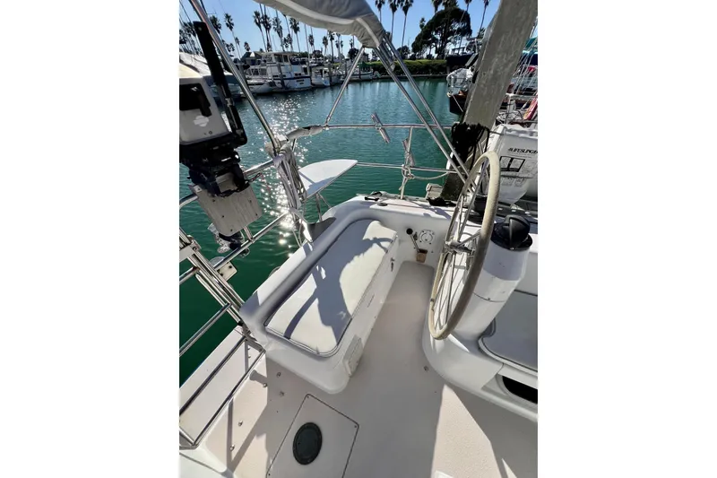 Slide: The Image of Cockpit of 1996 Catalina 400 sailboat with steering wheel and marina view. - 30