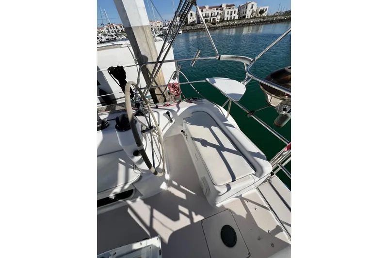 Slide: The Image of Cockpit of 1996 Catalina 400 sailboat with steering wheel and seating, docked in marina. - 31