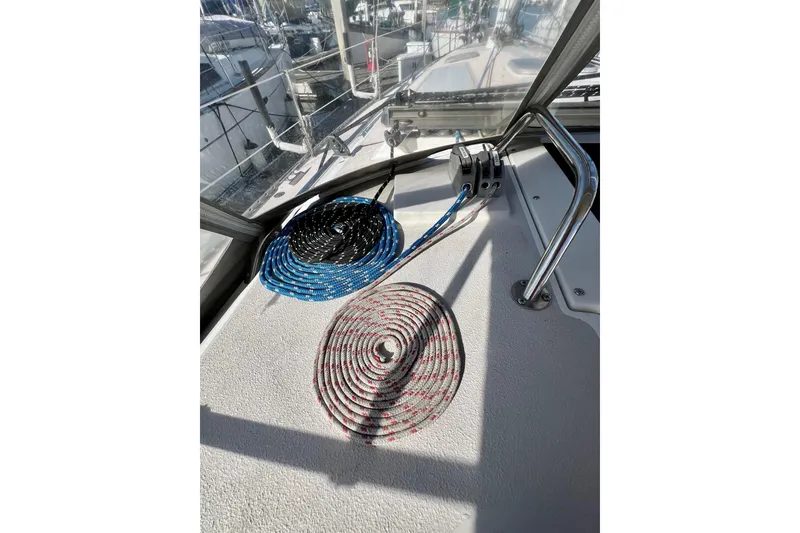 Slide: The Image of Coiled ropes on 1996 Catalina 400 sailboat deck, with marina view. - 36