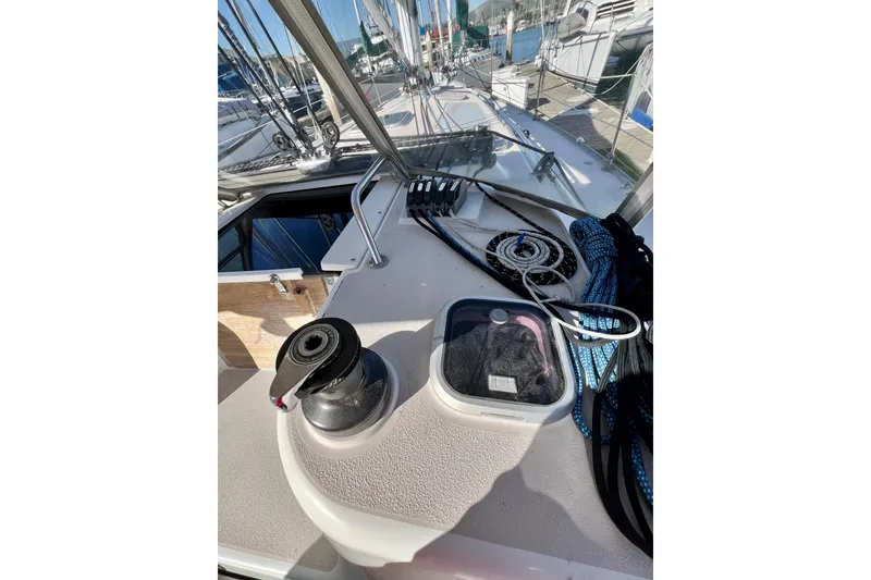Slide: The Image of 1996 Catalina 400 sailboat deck with winch, ropes, and hatch in marina. - 38