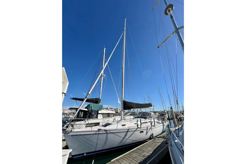 Slide: The Image of Sailboat Catalina 400, 1996 model, docked at marina under clear blue sky. - 4