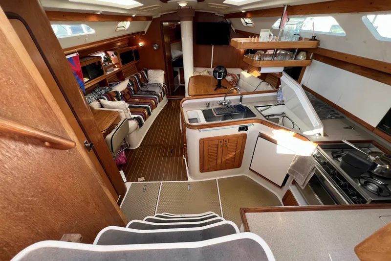 Slide: The Image of Interior of a 1996 Catalina 400 yacht with kitchen and seating area. - 40