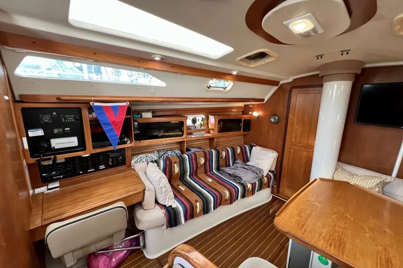 Slide: The Image of Interior of a 1996 Catalina 400 sailboat with cozy seating and wooden finishes. - 41