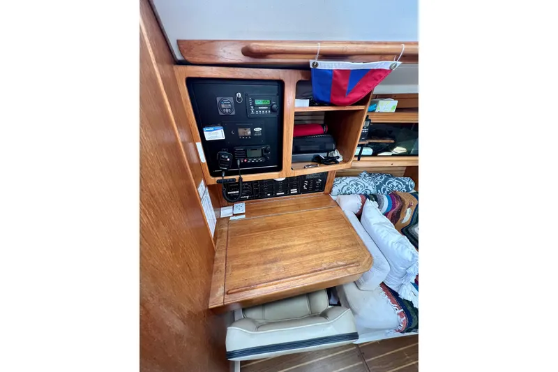 Slide: The Image of 1996 Catalina 400 yacht interior with navigation panel and wooden cabinetry. - 42