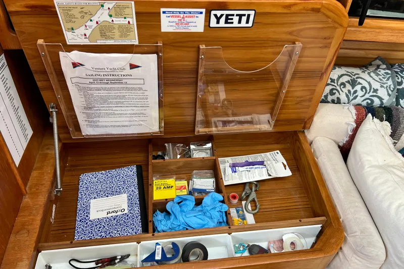 Slide: The Image of Interior of a 1996 Catalina 400 sailboat with organized storage and sailing instructions. - 43