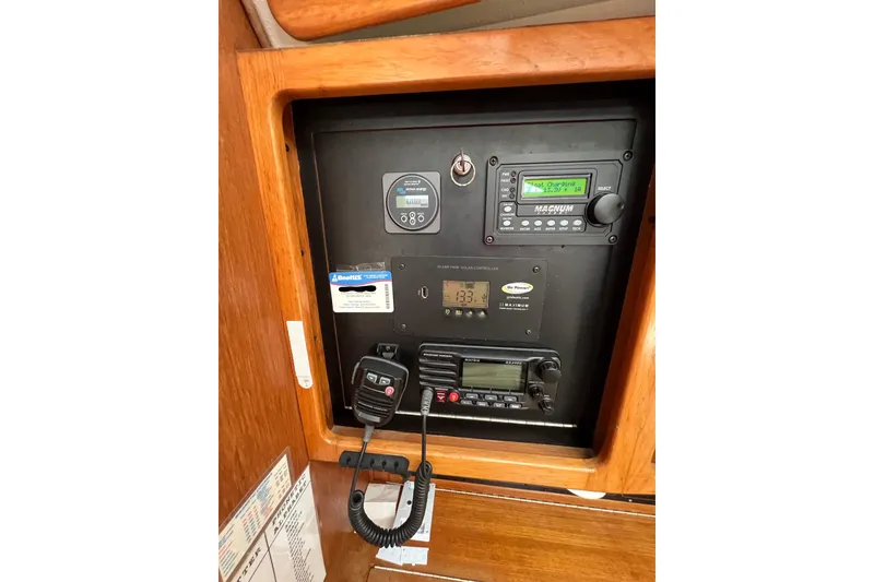 Slide: The Image of Control panel of a 1996 Catalina 400 sailboat with various electronic displays and equipment. - 44