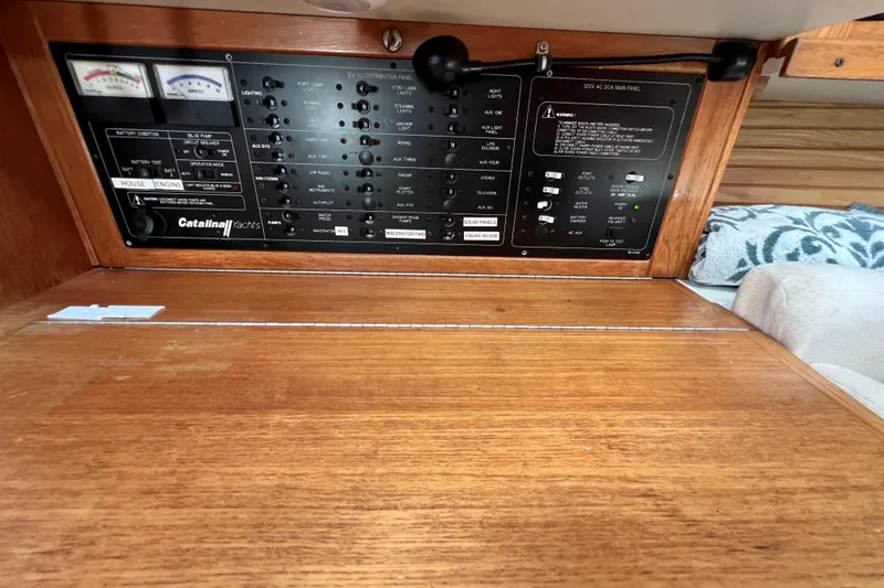 Slide: The Image of Control panel of a 1996 Catalina 400 yacht, featuring various switches and gauges. - 45