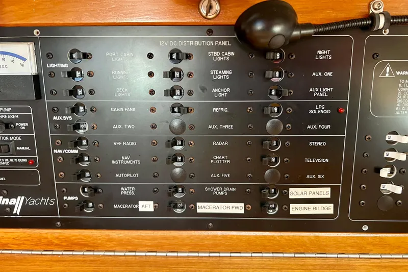Slide: The Image of Control panel of a 1996 Catalina 400 yacht with various switches and indicators. - 47