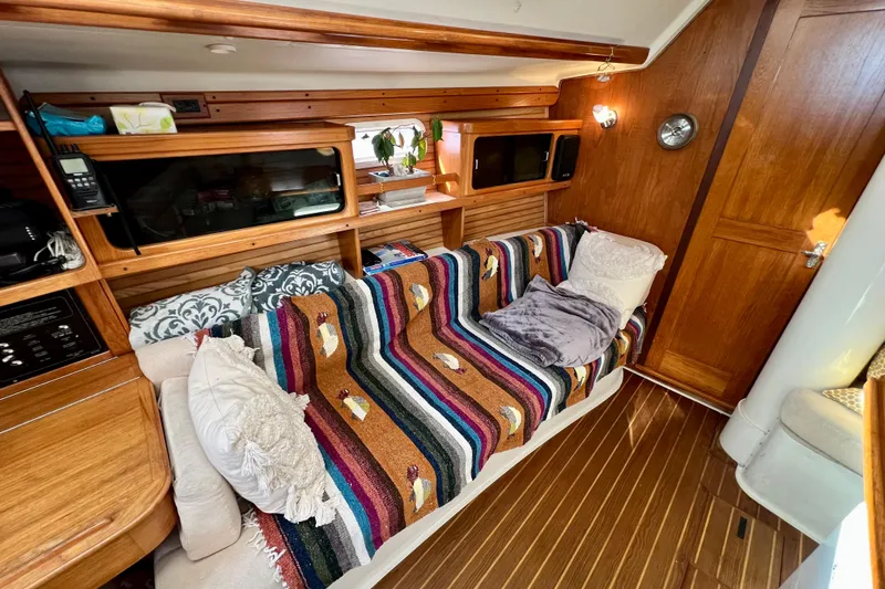 Slide: The Image of Interior of 1996 Catalina 400 sailboat with colorful blanket and wooden finish. - 49