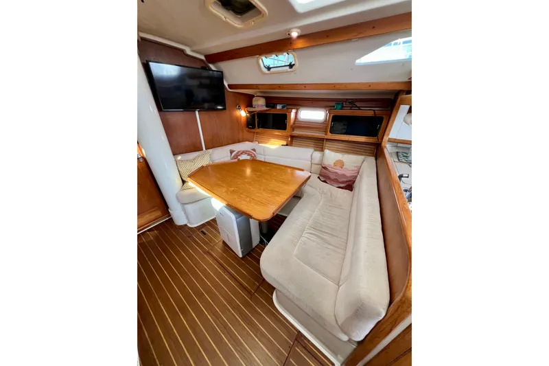 Slide: The Image of Cozy interior of 1996 Catalina 400 sailboat with dining area and TV. - 50