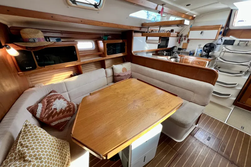 Slide: The Image of Cozy interior of a 1996 Catalina 400 sailboat with dining area and kitchen. - 53