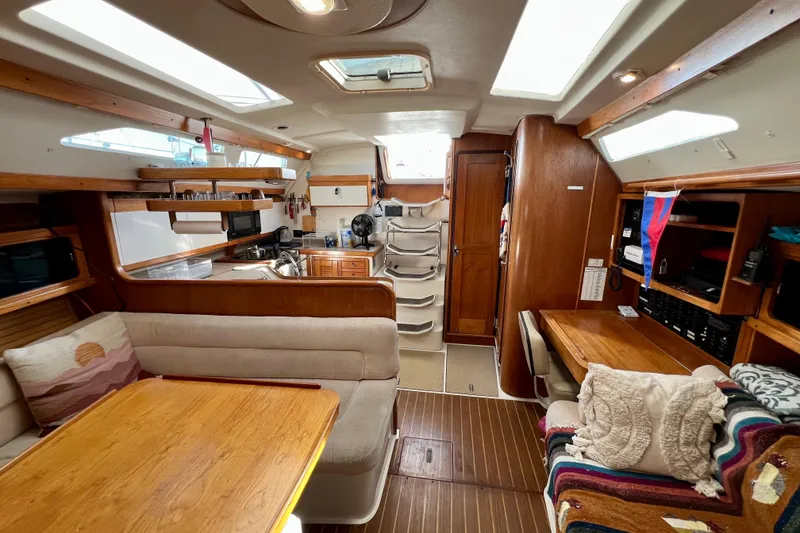 Slide: The Image of Interior of a 1996 Catalina 400 sailboat with cozy seating and wooden finishes. - 54