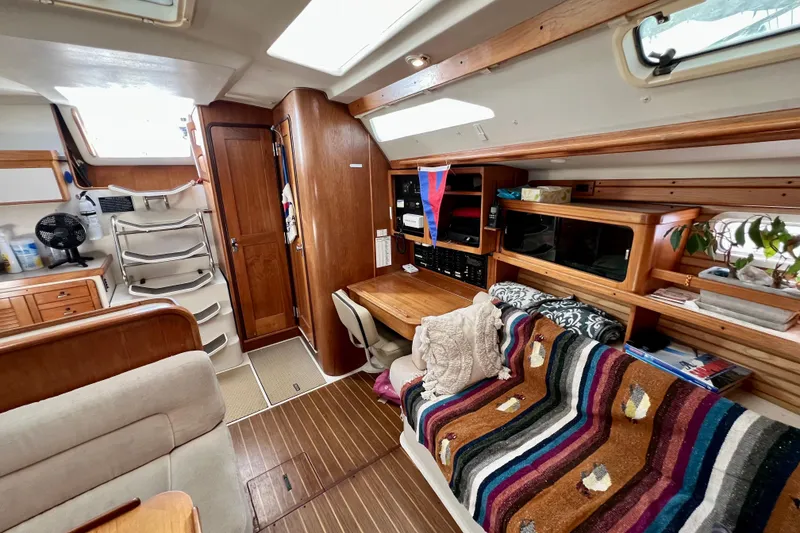 Slide: The Image of Cozy interior of a 1996 Catalina 400 sailboat with wood accents and colorful decor. - 55