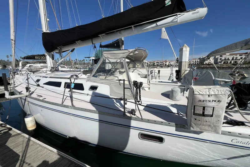 Slide: The Image of Sailboat Catalina 400, 1996 model, docked at marina with clear blue sky. - 6