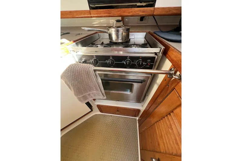 Slide: The Image of 1996 Catalina 400 yacht kitchen with stove, oven, and pot on burner. - 61