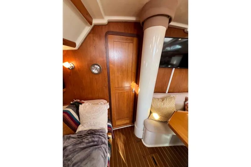 Slide: The Image of Interior of 1996 Catalina 400 sailboat with cozy seating and wooden accents. - 64