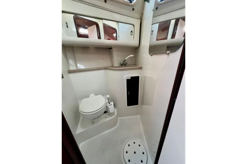 Slide: The Image of Bathroom interior of a 1996 Catalina 400 yacht, featuring a toilet and sink. - 69