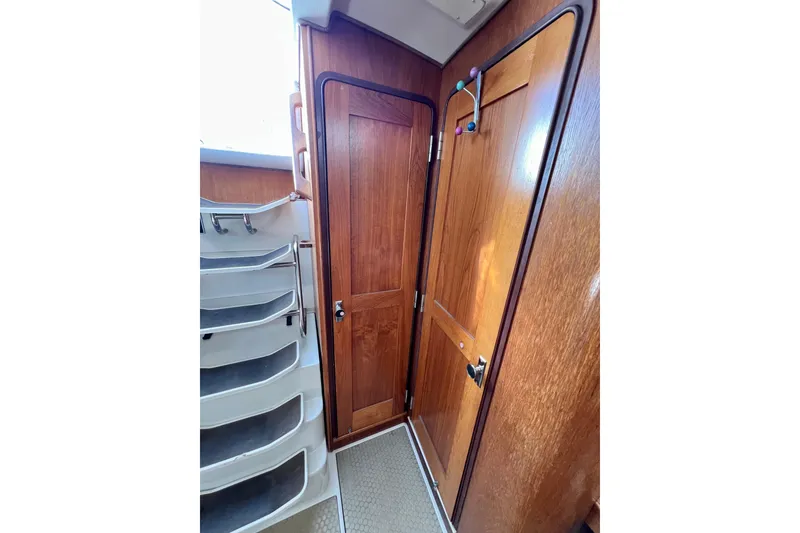 Slide: The Image of Interior of 1996 Catalina 400 sailboat with wooden doors and staircase. - 70