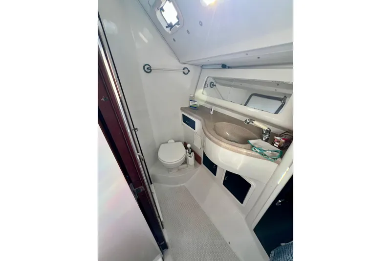 Slide: The Image of Bathroom interior of a 1996 Catalina 400 yacht, featuring sink and toilet. - 71