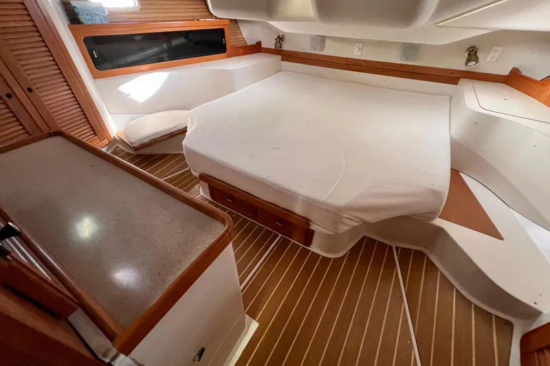 Slide: The Image of Interior of 1996 Catalina 400 yacht with cozy bed and wooden accents. - 72