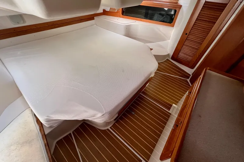 Slide: The Image of Interior cabin of 1996 Catalina 400 sailboat with wooden flooring and cozy bed. - 74