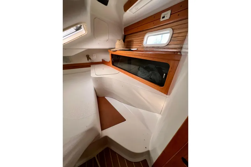 Slide: The Image of Interior cabin of a 1996 Catalina 400 sailboat with wooden accents and a small window. - 75