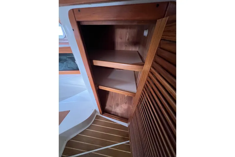 Slide: The Image of Wooden interior shelving in a 1996 Catalina 400 sailboat cabin. - 77