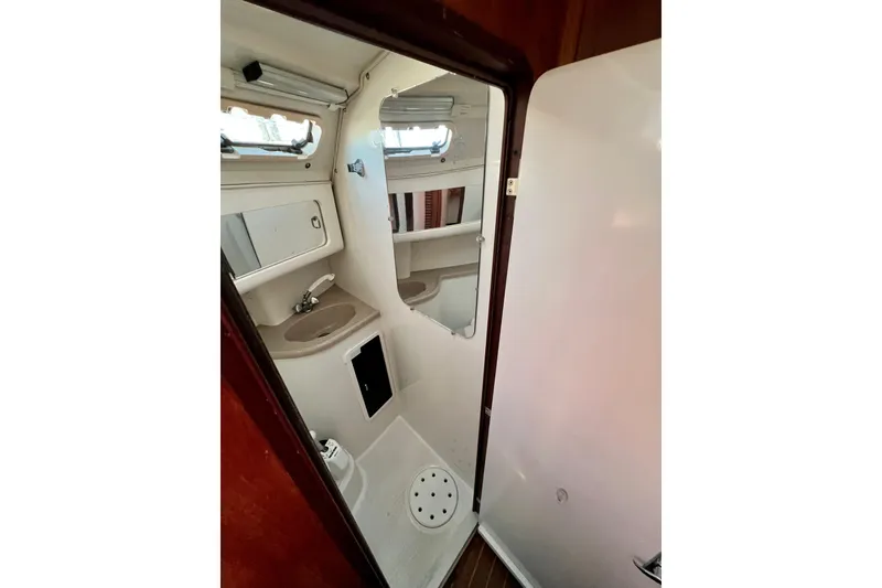Slide: The Image of Bathroom interior of 1996 Catalina 400 sailboat, featuring sink and shower. - 80