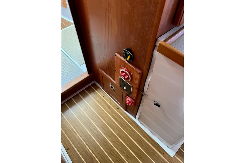 Slide: The Image of Control panel on 1996 Catalina 400 yacht with wooden flooring and switches. - 83