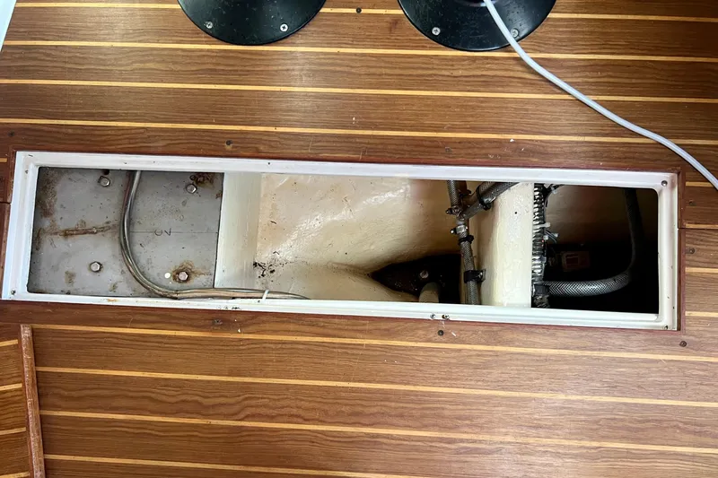 Slide: The Image of Open compartment in 1996 Catalina 400 sailboat, showing interior components and wiring. - 84