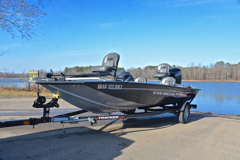 Slide: The Image of 2022 Bass Tracker 175 TF boat on trailer by a lake, clear blue sky. - 10