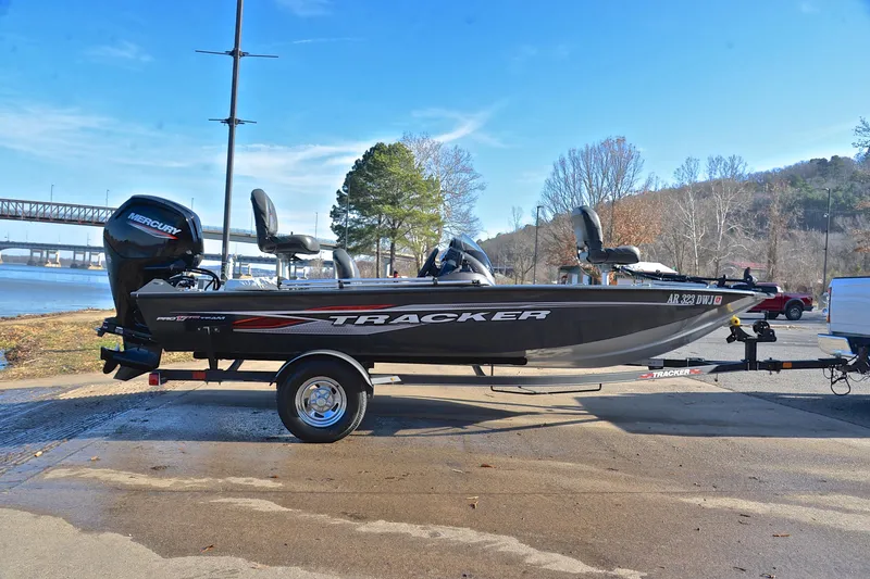 Slide: The Image of 2022 Bass Tracker 175 TF boat on trailer by riverside, clear sky background. - 15