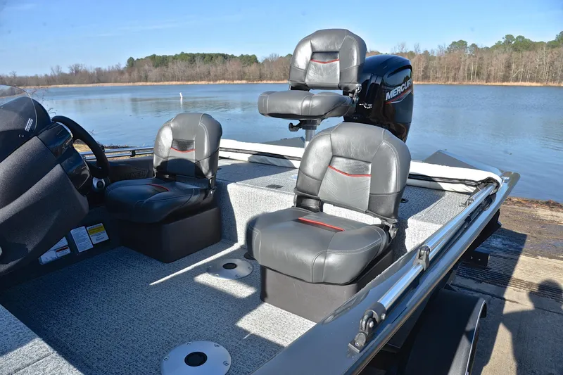 Slide: The Image of 2022 Bass Tracker 175 TF boat with gray seating, docked by a serene lake. - 18