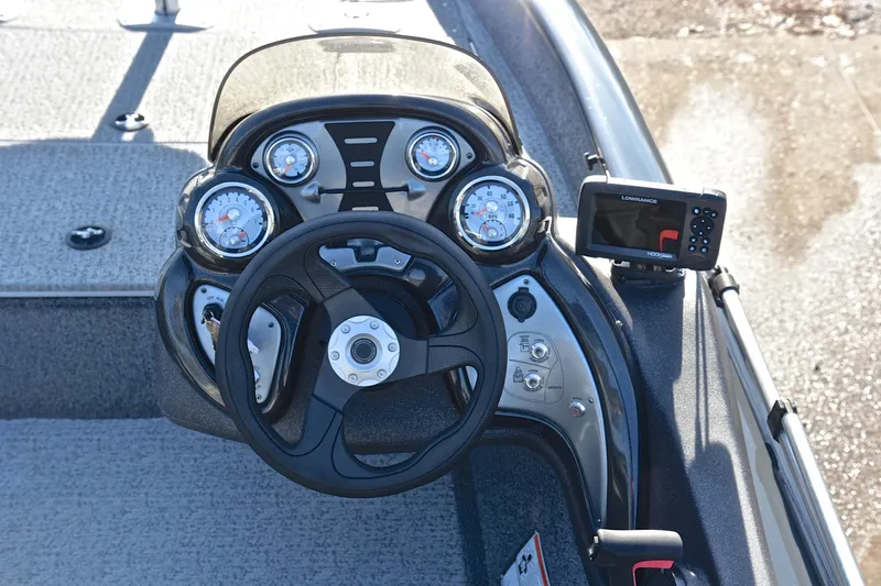 Slide: The Image of Bass Tracker 175 TF 2022 boat dashboard with steering wheel and gauges. - 24