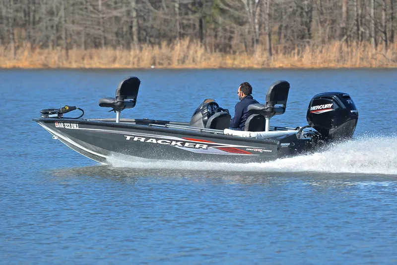 Slide: The Image of 2022 Bass Tracker 175 TF boat cruising on a lake with Mercury engine. - 4
