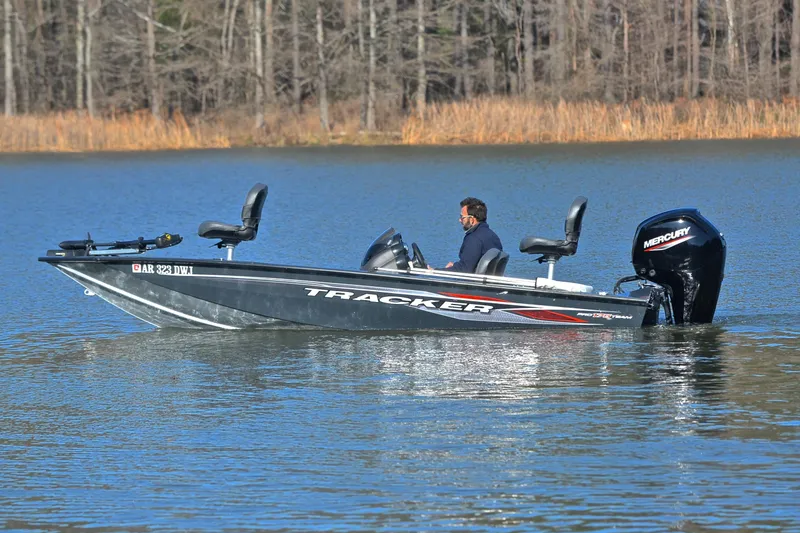 Slide: The Image of 2022 Bass Tracker 175 TF boat on a calm lake with a Mercury engine. - 9