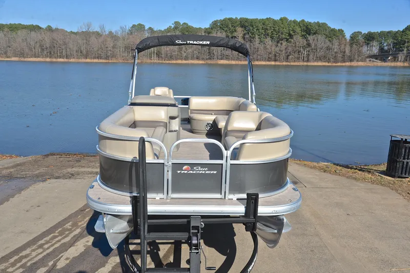 Slide: The Image of 2025 Sun Tracker Party Barge 18 DLX pontoon boat on a lake ramp. - 17