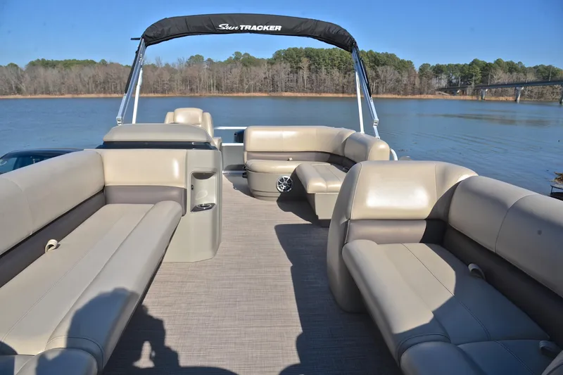Slide: The Image of 2025 Sun Tracker Party Barge 18 DLX pontoon boat on a serene lake. - 20
