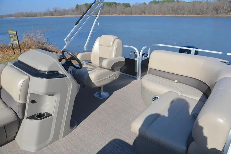 Slide: The Image of 2025 Sun Tracker Party Barge 18 DLX pontoon boat interior by a serene lake. - 22