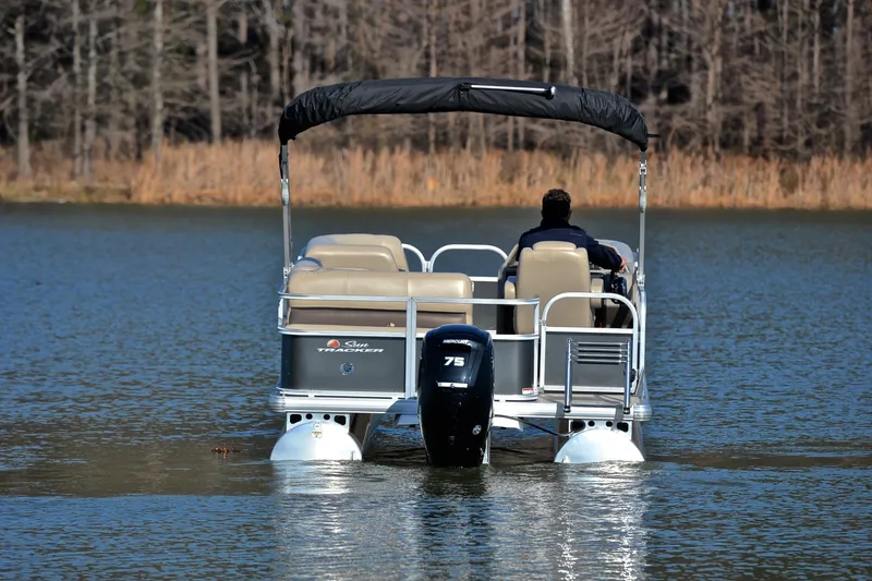 Slide: The Image of 2025 Sun Tracker Party Barge 18 DLX pontoon boat on a serene lake. - 7