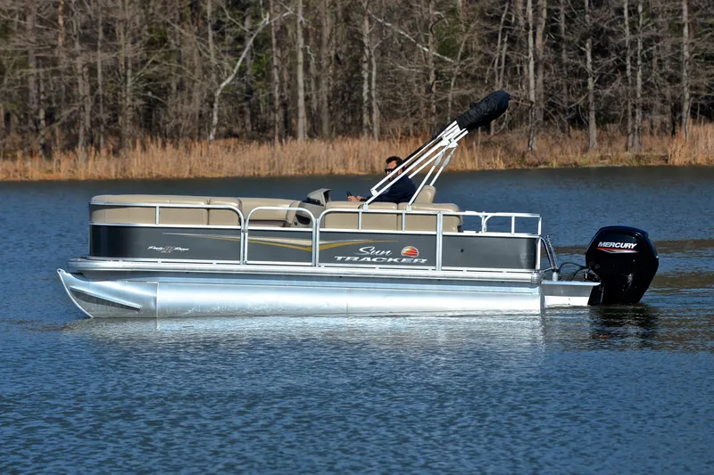 Slide: The Image of 2025 Sun Tracker Party Barge 18 DLX pontoon boat on a serene lake. - 8
